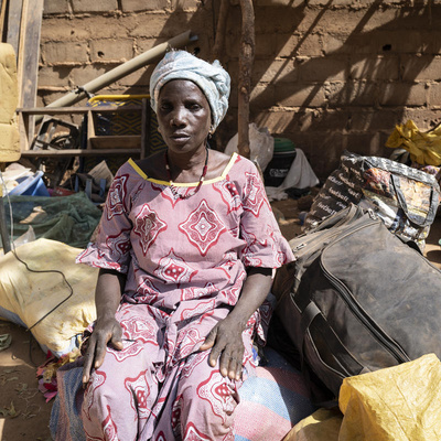 An internally displaced Burkinabe woman sits among belongings in Kaya, Burkina Faso, February 2020.