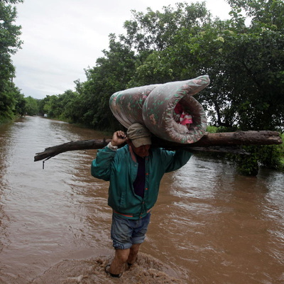 Honduras. Man carries his belongings through a flooded road after the passing of Storm Iota, in Marcovia