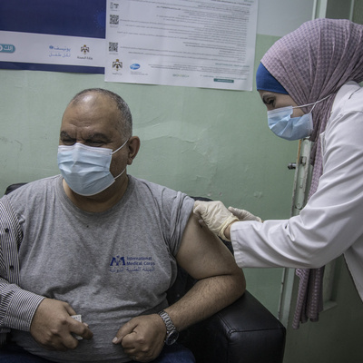 Iraqi refugee Ziad receives a dose of COVID-19 vaccine at the Irbid Vaccination Clinic in Jordan.