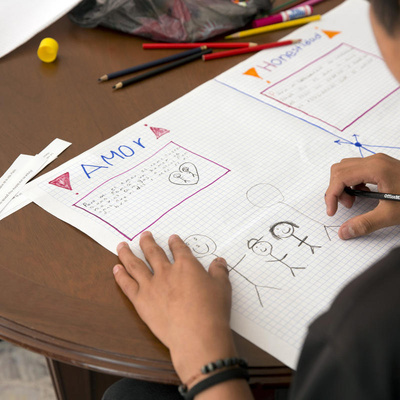 A child draws at a UNHCR-supported shelter in Mexico City for unaccompanied minors from northern Central America, November 2019.