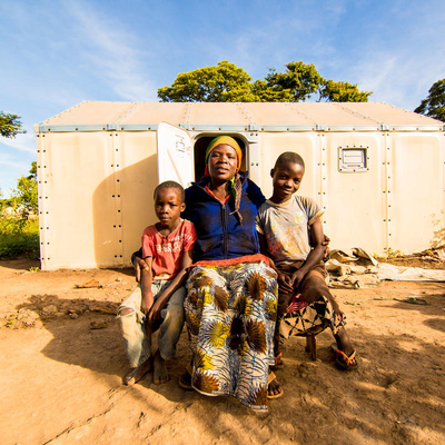 Burundian refugee Velarie Ntahonicaye and her family pose outside their home in Kigoma Refugee Camp, Tanzania, April 2019.