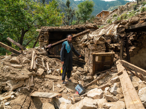 A man points at the rubble of his home following an earthquake in Kunar province, eastern Afghanistan.