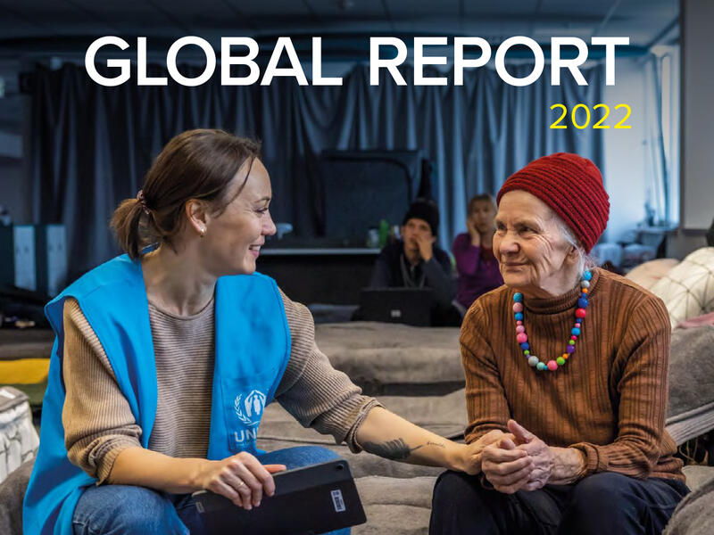 Global Report 2022 cover, featuring a photo a a UNHCR staff member comforting  a refugee from Ukraine. 