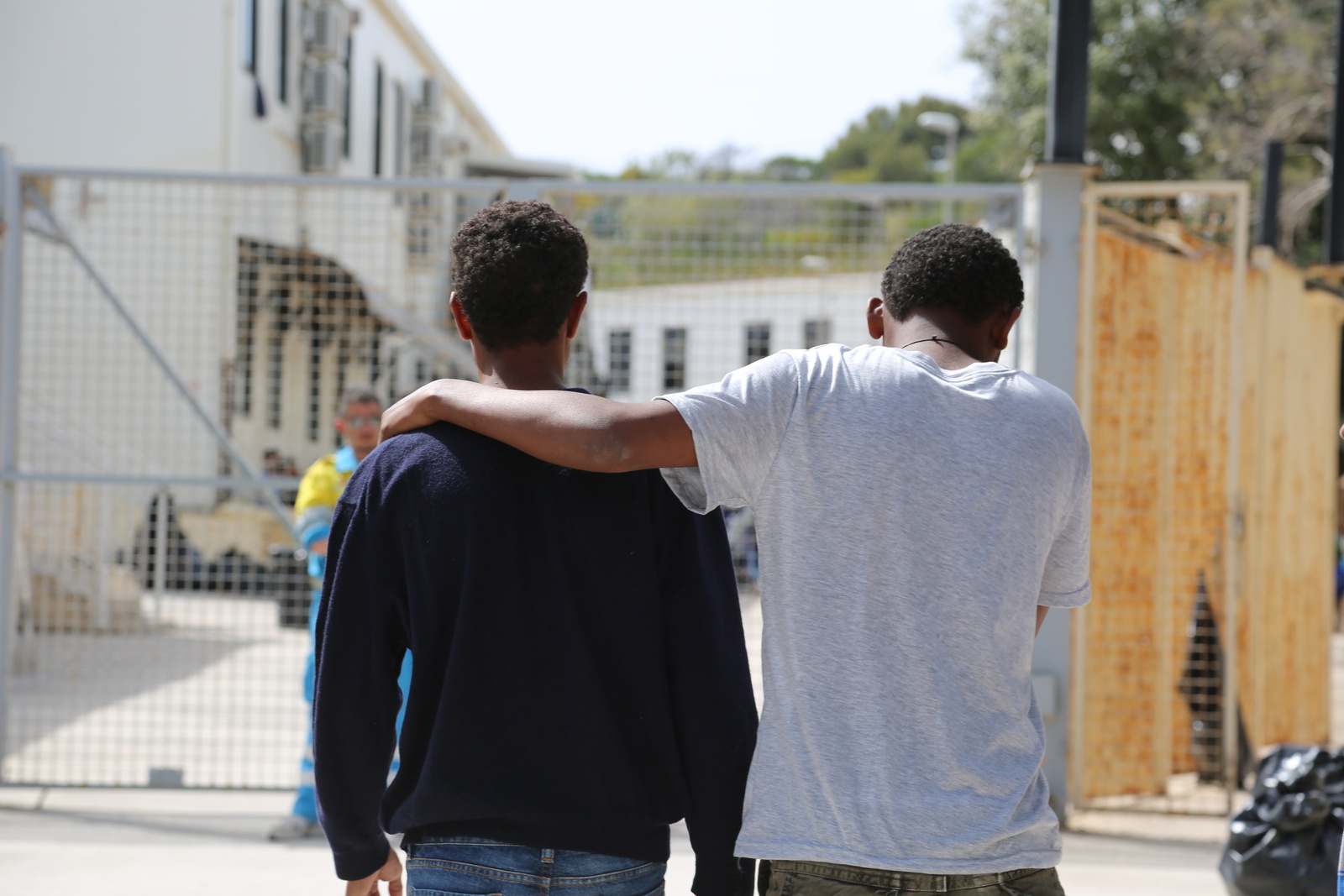 These two rescued men wait at a reception centre in Lampedusa for news of friends and relatives in need of medical treatment.