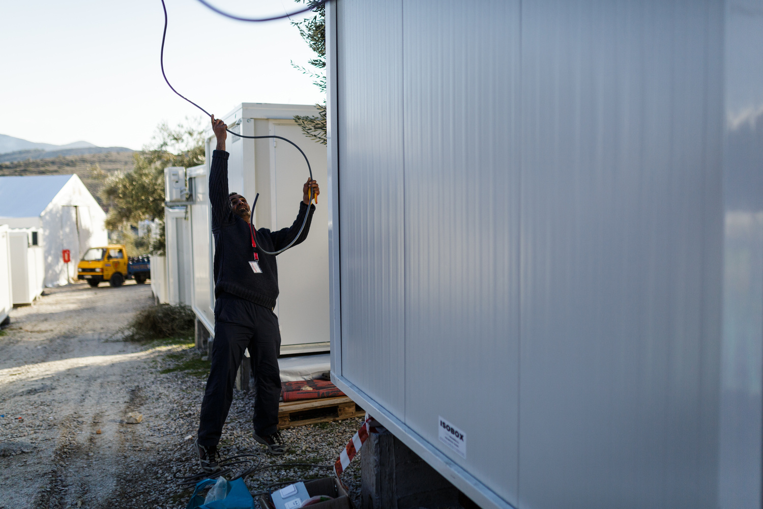 Greece. The Syrian electrician installing power at Lesbos refugee camp