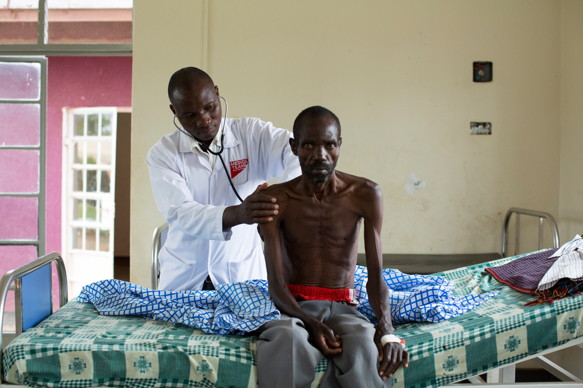 Uganda. Cancer-stricken refugee nurse cares for the sick