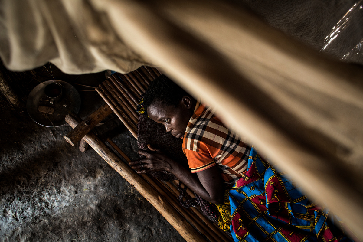 Democratic Republic of Congo. A Central African Refugee lies injured from a bullet wound in her house.