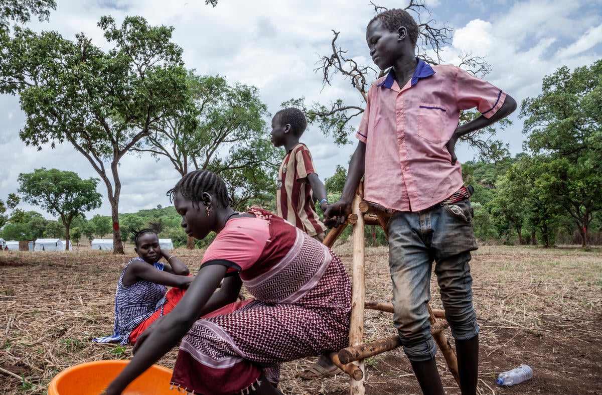Dinai and his siblings spend the day together in Gure Shombola Camp, Ethiopia.