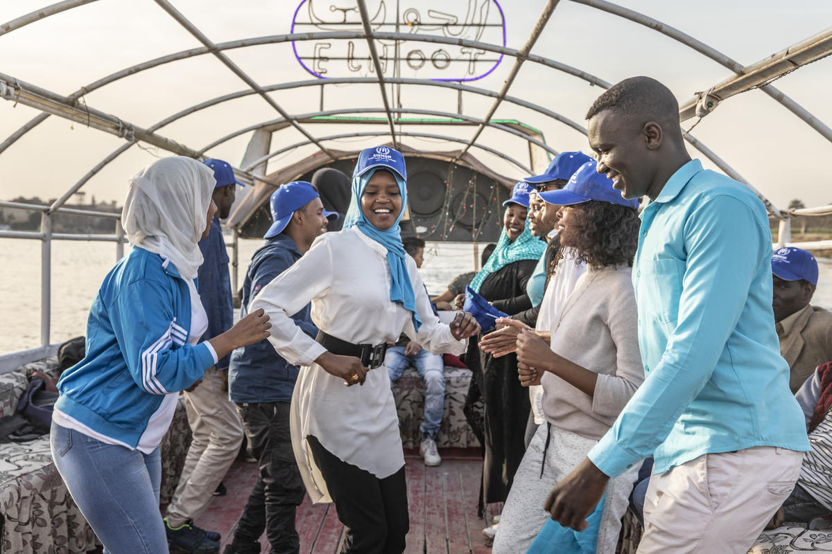 Egypt. Refugees and locals clean the Nile together