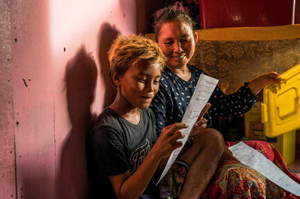 Arnel smiles as he reads his name on his birth certificate for the first time.