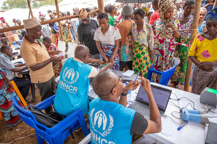 UNHCR staff help register refugees