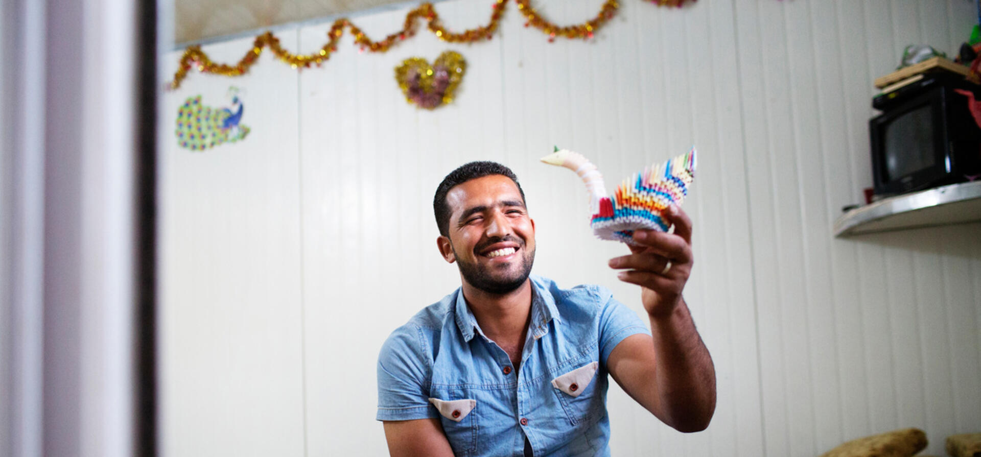 Jordan. 25-year-old Fadi Al Wali teaches origami to special needs children and other children at Za'atari refugee camp.