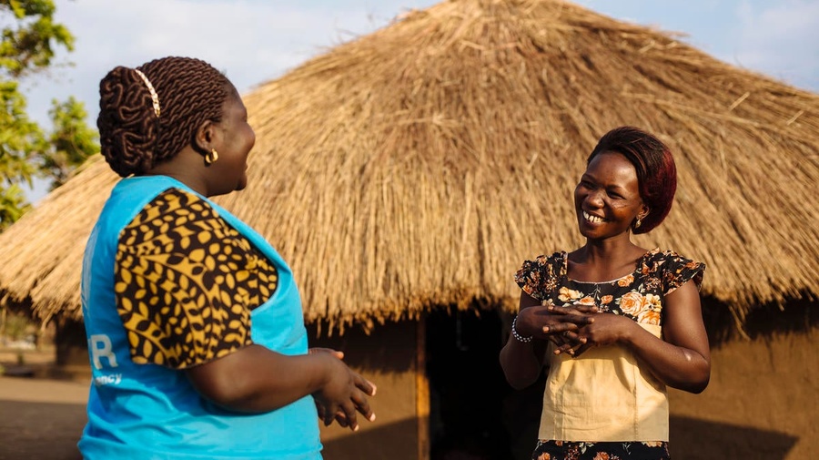 South Sudanese refugee speaks with a UNHCR staff member in Uganda. 