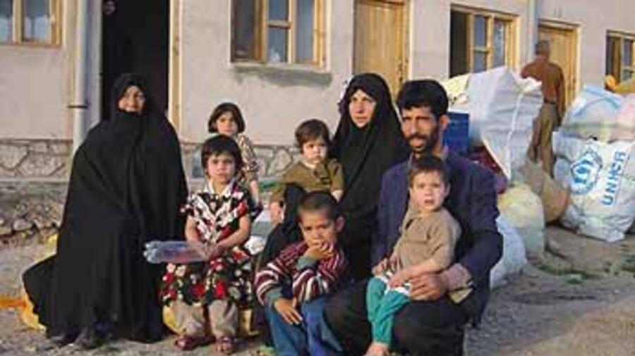 An Afghan family waits for transport home at the Gazergah Transit Distribution Centre in Herat.