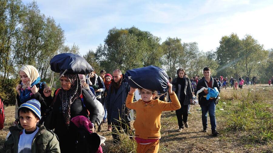 Refugees and migrants walk through a field in Slovenia after after crossing the border from Croatia in this 2015 file photo. 