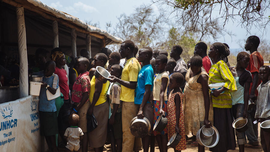 Uganda. South Sudanese refugees queue for food the Imvepi reception centre