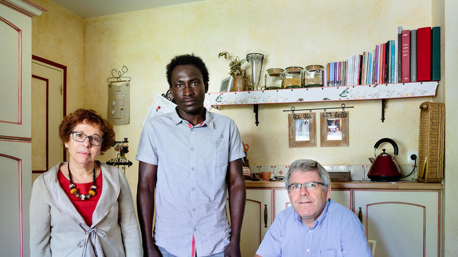 France. Annick and Hubert host Farah, a refugee from Sudan, in Rivière.  This portrait is part of the No Stranger Place series, which portrays locals and refugees living together