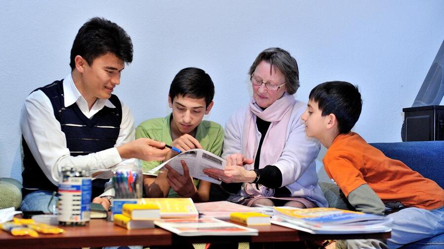 Austria. Shokat Ali who arrived in Austria in 2008 helping a family of recent arrivals from Afghanistan. Seen here with the family's host.