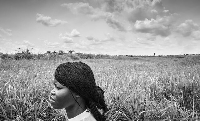 Refugee woman in field, black and white