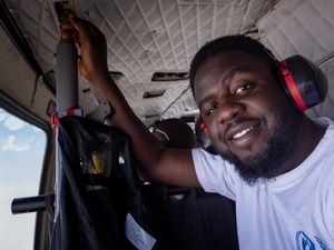 UNHCR Field Associate Iliya Ishira travels by helicopter to Banki, Borno State, to support displaced and returning communities. © UNHCR/Andrew Prior 