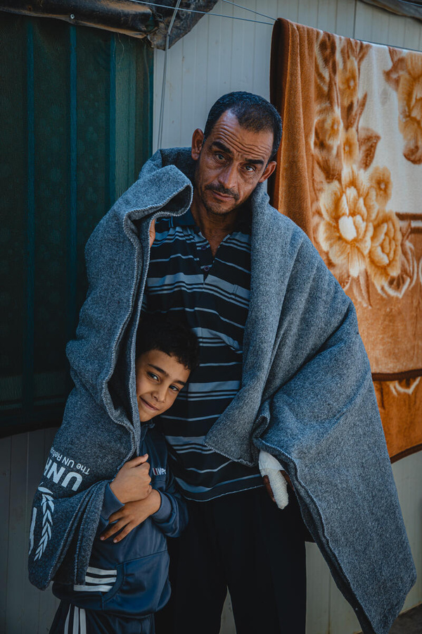 Jordan. Syrian refugee Muhamed and his two sons using UNHCR blanket