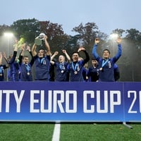 A group of people in uniform holding up their hands