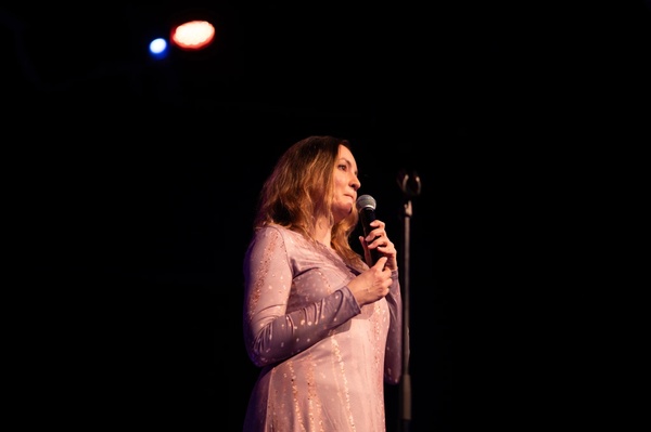 Galyna, from Ukraine, shares her story about being forced to leave her home twice, on the Maxim Theatre stage ©Ivanna Stytsun