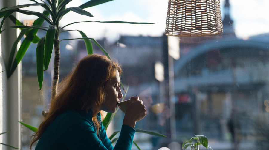 A person drinking from a cup