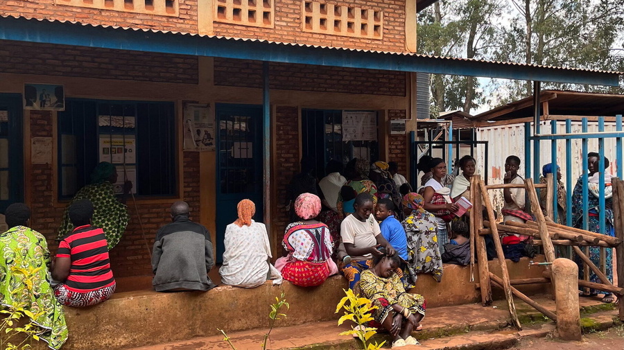 A group of people sitting outside a building