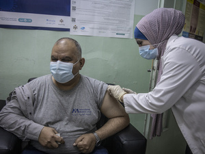Iraqi refugee Ziad receives a dose of COVID-19 vaccine at the Irbid Vaccination Clinic in Jordan.