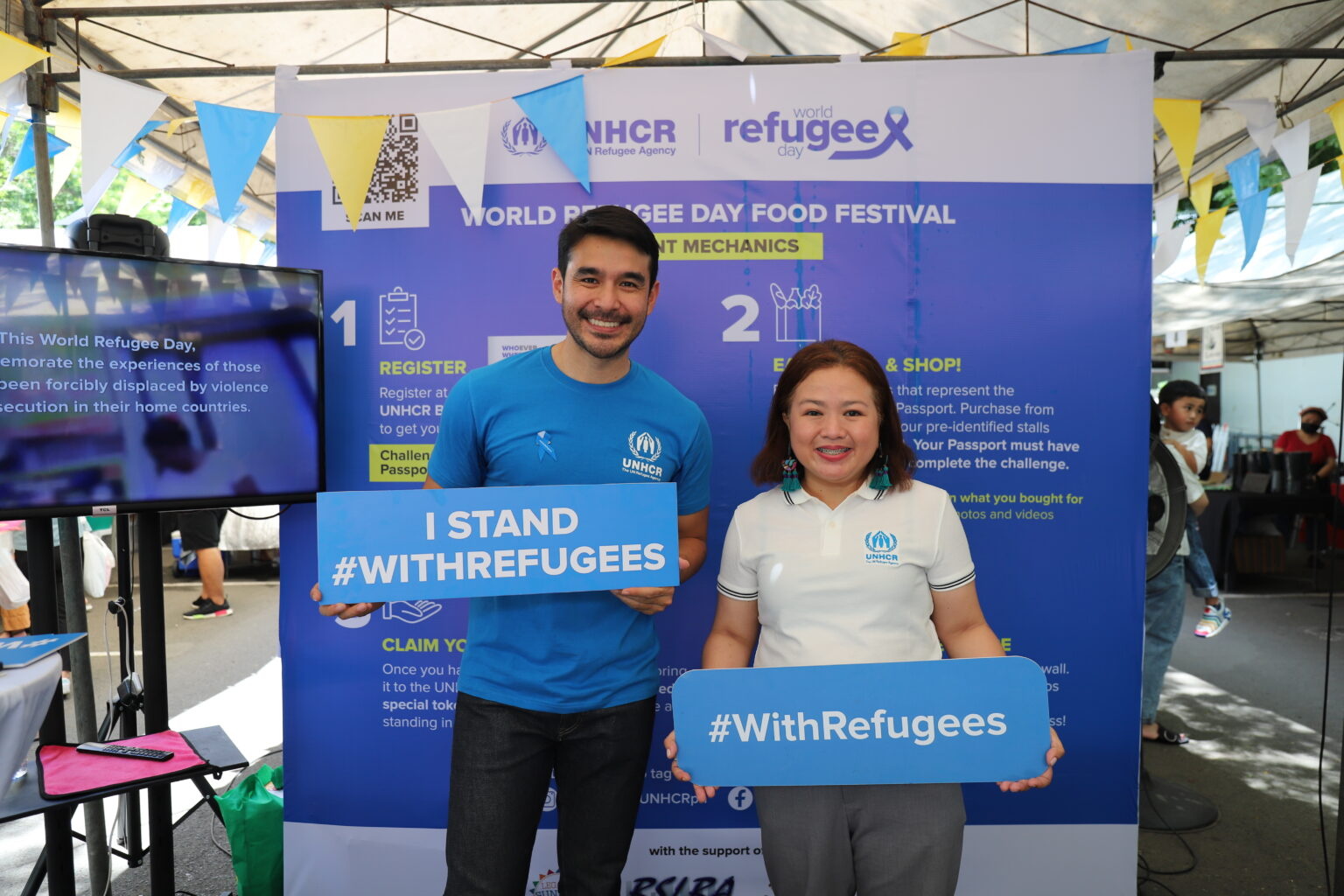 2 people holding banners