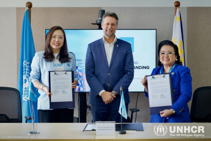 United Nations Resident Coordinator in the Philippines Arnaud Peral (centre) joins UNICEF Representative Kyungsun Kim and UNHCR Philippines Head of National Office Maria Ermina Valdeavilla-Gallardo at the signing of an agreement to deepen joint action on birth registration and ending childhood statelessness. 
