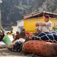 Ahmad, 15, and his younger brother Sahil, 12, are waiting at the Torkham border between Pakistan and Afghanistan with their family, after returning from Pakistan.