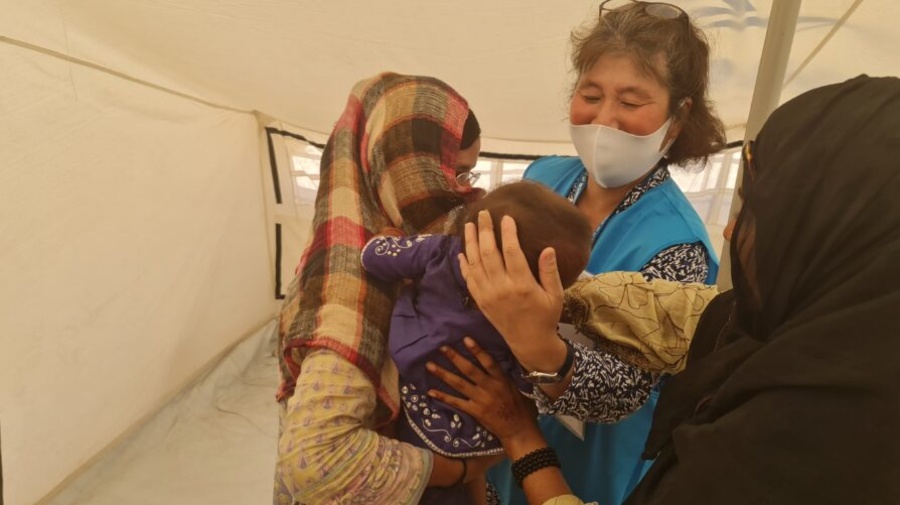 Ms. Noriko Yoshida, holding a child