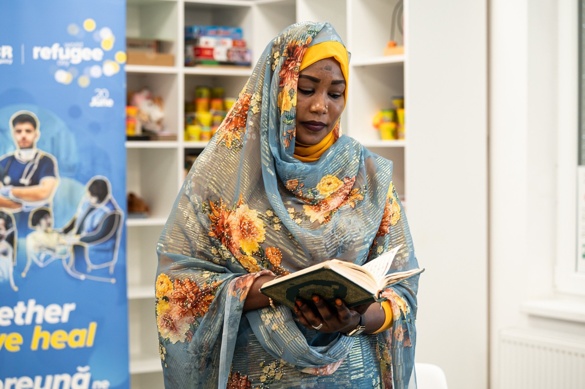 A woman holding and reading a Quran