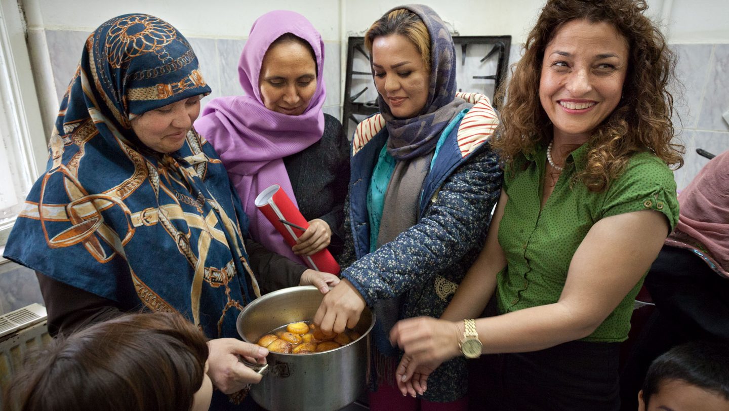 Refugee women in the kitchen of the Emergency Transic Center in