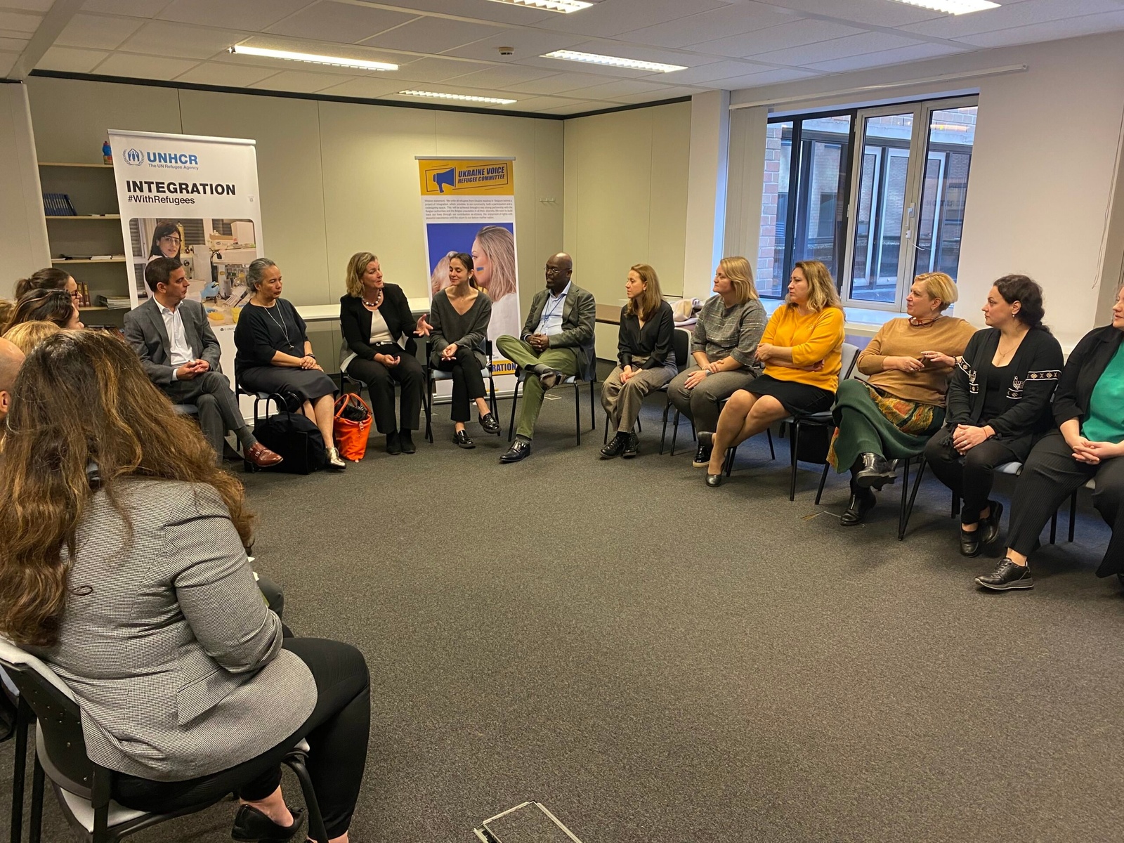 Kelly T. Clements, UNHCR’s Deputy High Commissioner, and Elizabeth Tan, Director of UNHCR’s Division of International Protection, exchange with refugees from Ukraine and other regions at the community centre. © UNHCR/Frederik Bordon