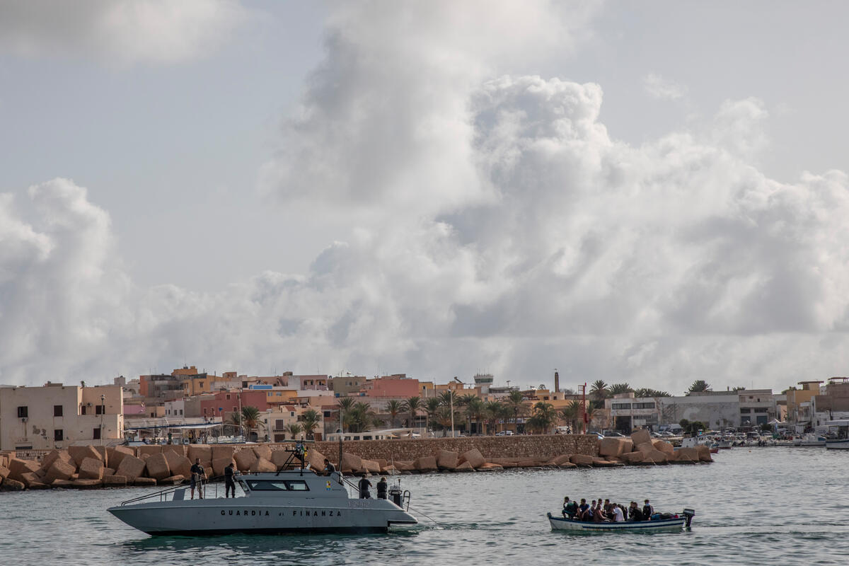 Rescued refugees and migrants disembark in Lampedusa