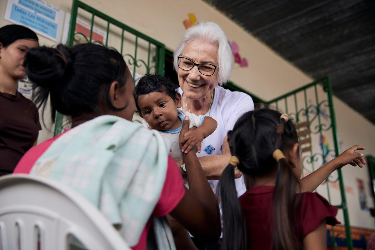 Sister Rosita Milesi holds a baby in her arms