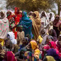لاجئون سودانيون يتجمعون في موقع مؤقت بكولبوس، تشاد، في مارس 2025 بعد فرارهم من النزاع في بلادهم.