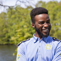 Emmanuel Tacima Samuel wearing a community Garda shirt.