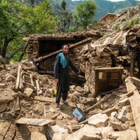 A man points at the rubble of his home following an earthquake in Kunar province, eastern Afghanistan.