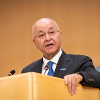 Barham Salih delivers a speech from a podium.