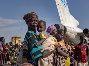 تنتظر أشول دينغ وابنتها رفقة مئات اللاجئين من جنوب السودان العائدين في مطار بالوش في ولاية أعالي النيل بجنوب السودان، بعد فرارهم من الصراع في السودان.