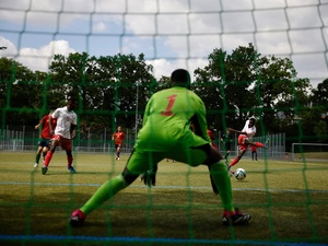 A player from the Spanish team aims for the Maltese goal at the Unity Cup in Frankfurt, Germany. The tournament was launched by UEFA and UNHCR to promote inclusion through sport. The 16 competing teams consist of refugee and host community players.