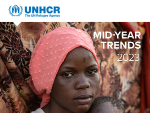 Cover of the Mid-Year Trends Report 2023, featuring a woman from South Sudan holding her infant sister.