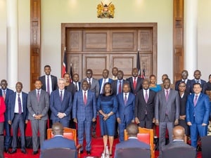 A group of people standing in two rows in front of an audience