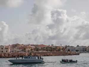 Rescued refugees and migrants disembark in Lampedusa
