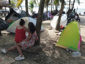 Families preparing to cross the Darien jungle camp on the beach in the Colombian city of Necoclí.