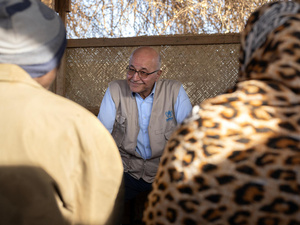 Barham Salih pictured speaking with two people whose backs are to the camera.